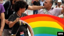 La activista Leannes Imbert sostiene la bandera del movimiento LGBT.